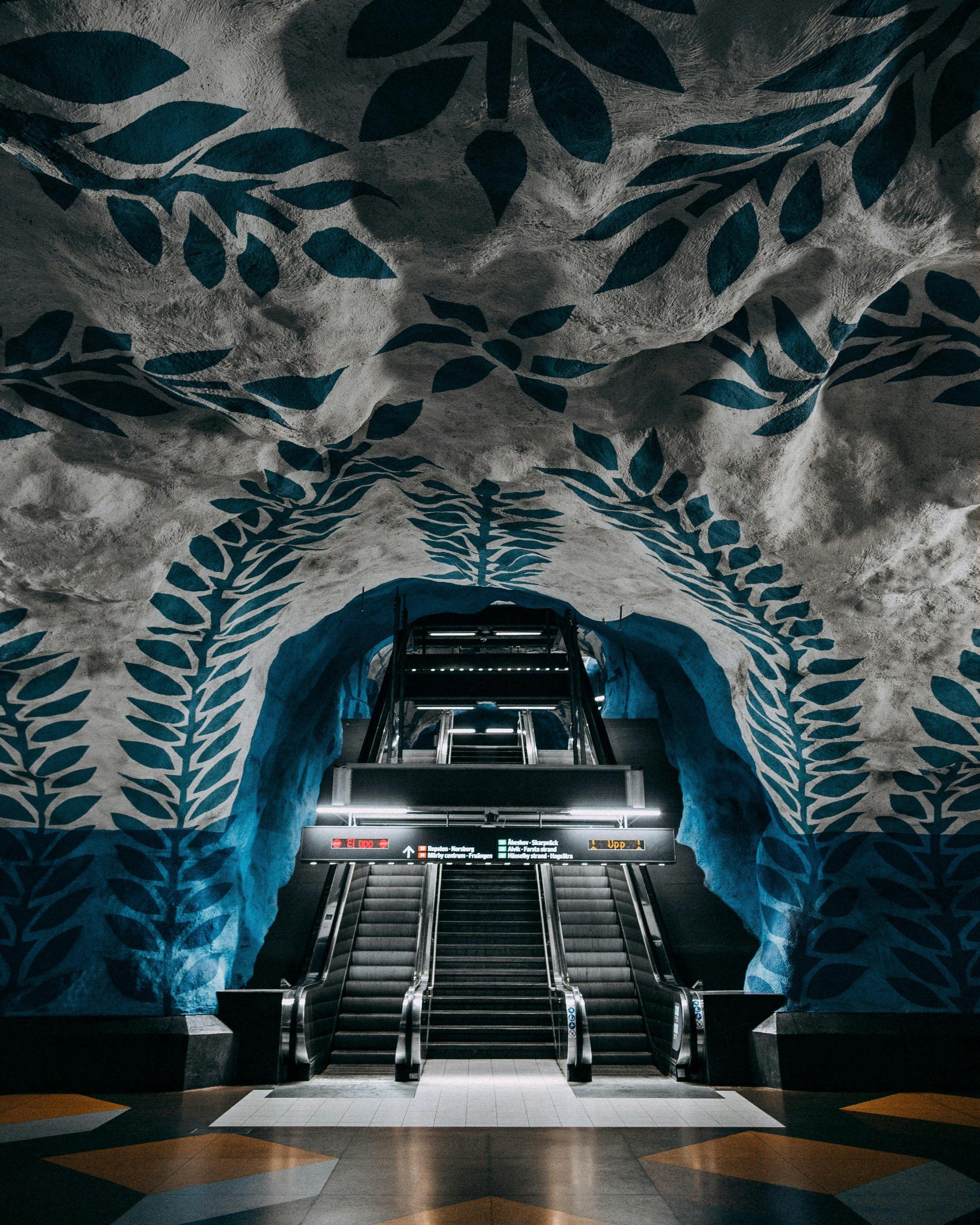 Discover Stockholm's T-Centralen metro station's iconic blue art design with central escalators.